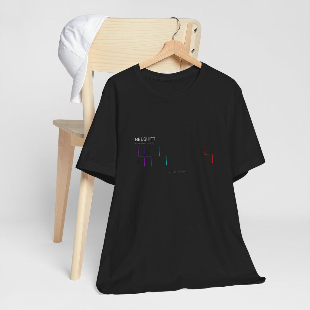 Redshift Spectra tee on a wooden hanger — hydrogen's lines, rest and redshifted, printed on black cotton.